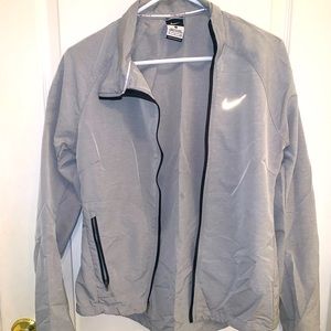 Small grey Nike windbreaker jacket.